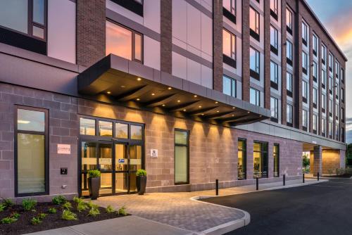 a rendering of a building with a sunset at Holiday Inn Express - Boston Logan Airport - Revere by IHG in Revere