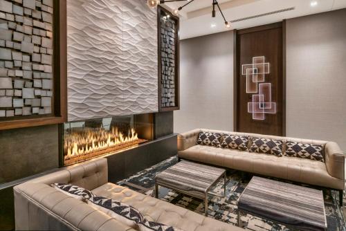 a lobby with two couches and a fireplace at Holiday Inn Express - Boston Logan Airport - Revere by IHG in Revere