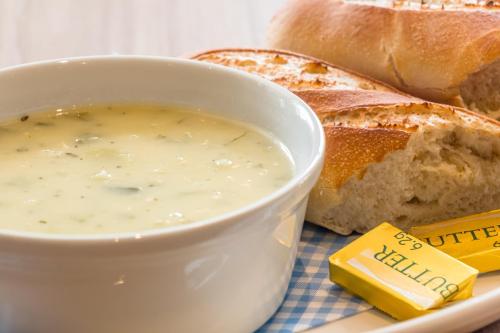 a bowl of cheese sauce next to a plate of bread at Holiday Inn Express - Bodmin - Victoria Junction by IHG in Bodmin
