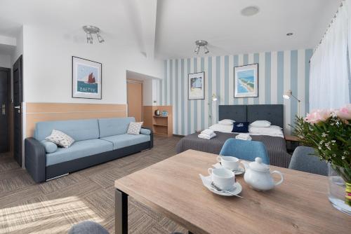 a living room with a couch and a table at Hotel Rejs in Władysławowo