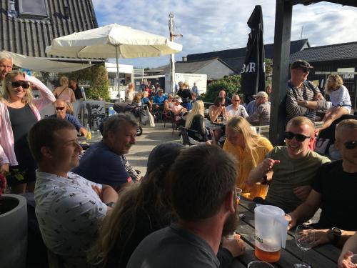 a group of people sitting around a table at Casablanca Hostel, hyggelig overnatning in Anholt