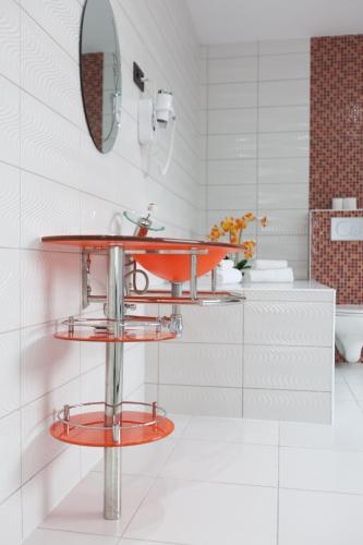 a bathroom with a red sink and a mirror at Hotel Phenix in Brussels