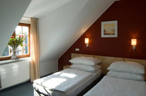 a bedroom with two beds and a window at Hotel Chvalská Tvrz in Prague