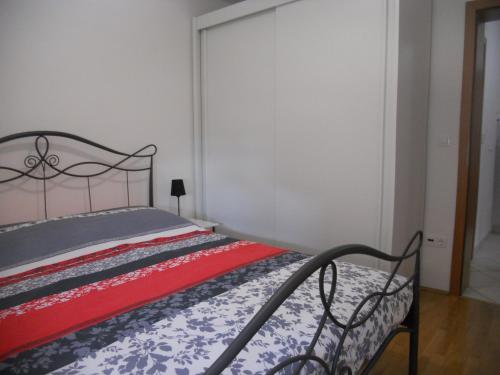 um quarto com uma cama com um cobertor vermelho e branco em 1 BR Apt - North Coast Croatia em Crikvenica