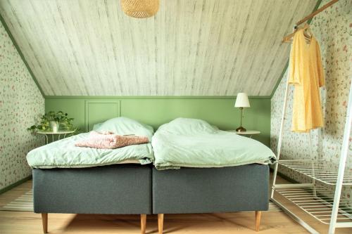 a bed in a room with a ceiling at Anettes Bed & Breakfast Falster in Eskilstrup