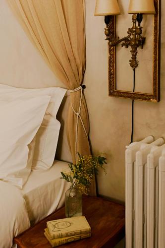 a bedroom with a bed and a table with a book at Shila Athens in Athens
