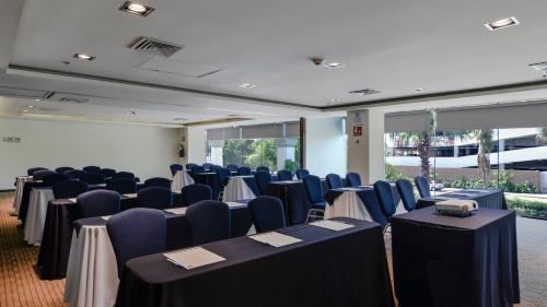 a room with rows of tables and blue chairs at Holiday Inn Express Culiacan by IHG in Culiacán