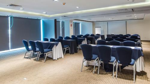 a room with rows of tables and blue chairs at Holiday Inn Express Culiacan by IHG in Culiacán