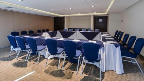 a conference room with a long table and blue chairs at Holiday Inn Express Culiacan by IHG in Culiacán