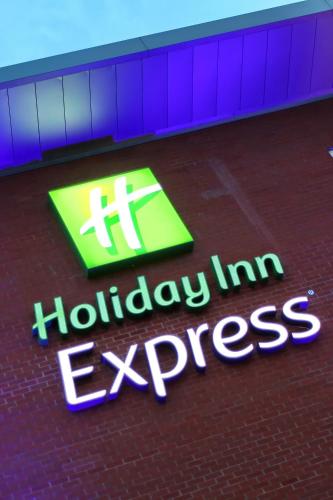 a sign that says holiday inn express in a building at Holiday Inn Express Birmingham Redditch by IHG in Redditch