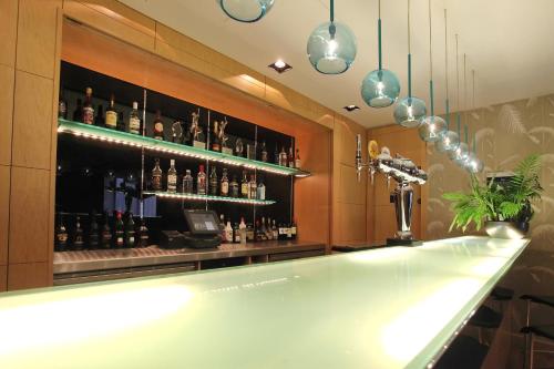 a bar with a lot of bottles of alcohol at Holiday Inn Express Birmingham Redditch by IHG in Redditch