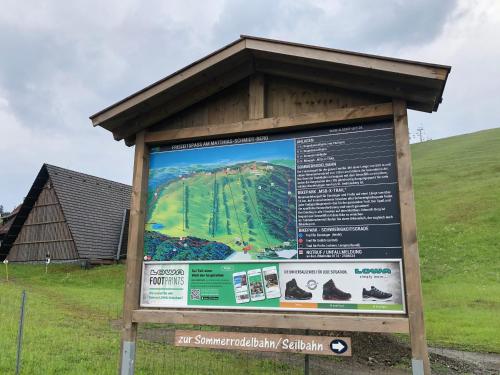 a sign in a field next to a building at Breeman im Harz in Sankt Andreasberg