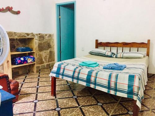 a bedroom with a bed and a fireplace at Sítio Refúgio do Eneas - Vista para o Mar in Parati-Mirim