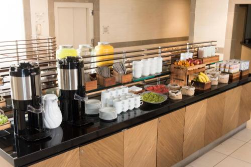 a kitchen with a counter with food and drinks at Holiday Inn Express - Iquique by IHG in Iquique