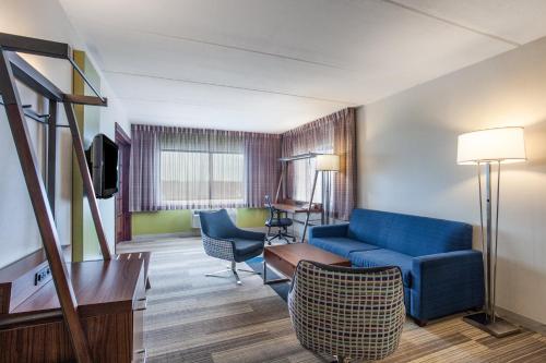 a living room with a blue couch and chairs at Holiday Inn Express Hauppauge-Long Island by IHG in Hauppauge