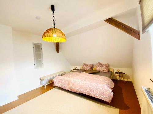 a bedroom with a bed and a couch and a lamp at Into The Green Apartment in Markt Nordheim