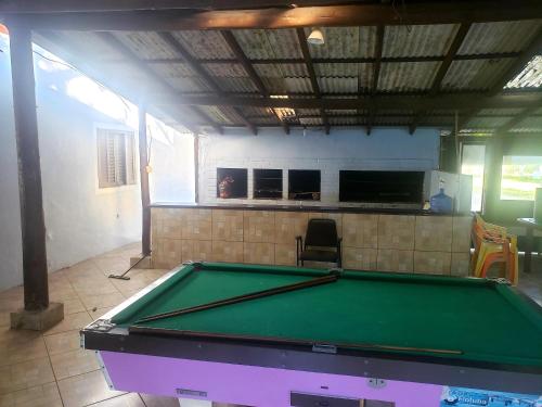 a ping pong table in a room with a pool table at Guesthouse da Barra in Florianópolis