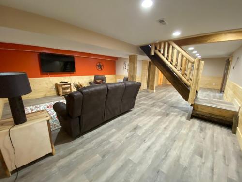 a living room with a couch and a flat screen tv at Pine Creek Cabins & Camping Resort in South Bloomingville
