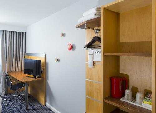 a room with a desk and a computer in a room at Holiday Inn Express London - Epsom Downs by IHG in Epsom