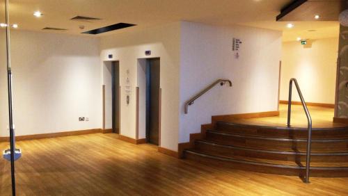 a room with a staircase in a building at Holiday Inn Express London - Epsom Downs by IHG in Epsom