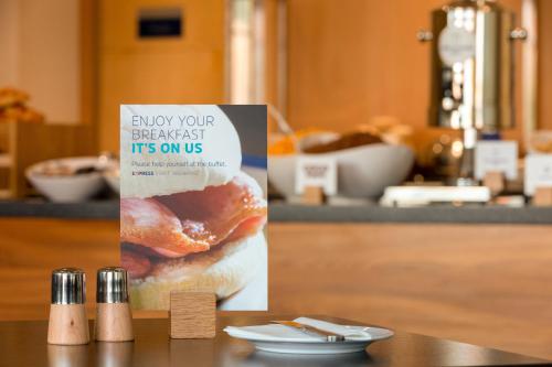 a sign on a table with a bag of donuts at Holiday Inn Express Birmingham Redditch by IHG in Redditch