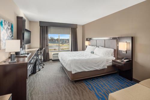 a hotel room with a bed and a desk at Holiday Inn Owensboro Riverfront, an IHG Hotel in Owensboro
