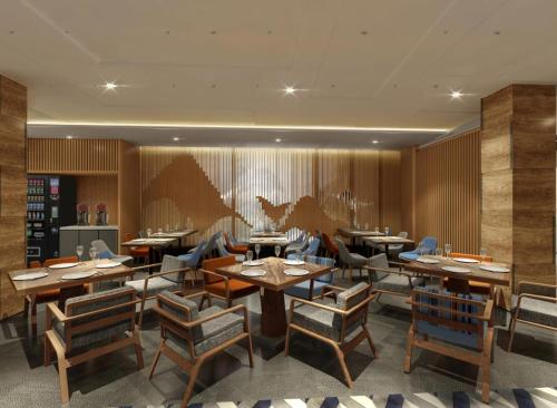 a restaurant with wooden walls and tables and chairs at Holiday Inn Express Jiuzhaigou,Only 600 Meters to Jiuzhaigou Park by IHG in Jiuzhaigou