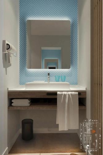 a bathroom with a sink and a mirror at Holiday Inn Express Jiuzhaigou in Jiuzhaigou