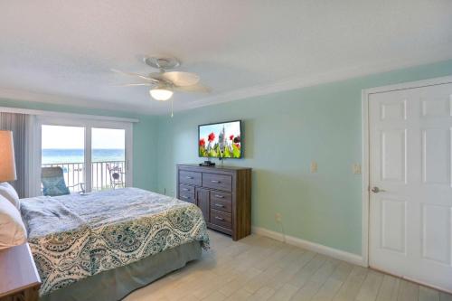 a bedroom with a bed and a view of the ocean at 106 Seagate in Clearwater Beach