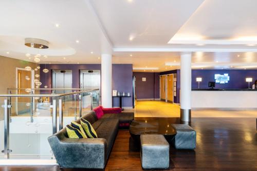 a living room with a couch and a table at Holiday Inn Express Dundee by IHG in Dundee