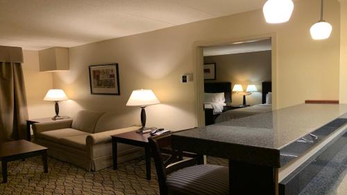 a hotel room with a couch and a living room at Holiday Inn Express Milford, an IHG Hotel in Milford