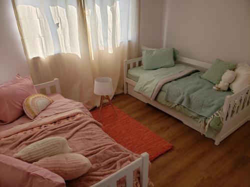 Postelja oz. postelje v sobi nastanitve Al Nair Casa de playa RESERVA CON SEÑA