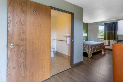 a room with a room with a bed and a bathroom at Super 8 by Wyndham Abingdon VA in Abingdon