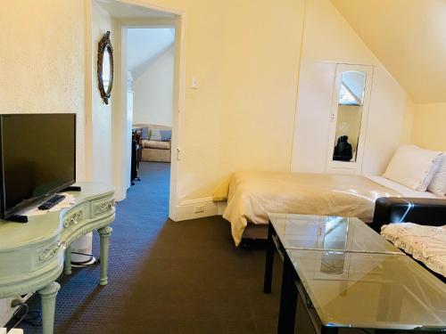 a hotel room with a bed and a tv at The Mews Motel in Launceston