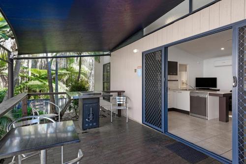 a living room with a kitchen and a dining area at Discovery Parks - Emerald Beach in Emerald Beach