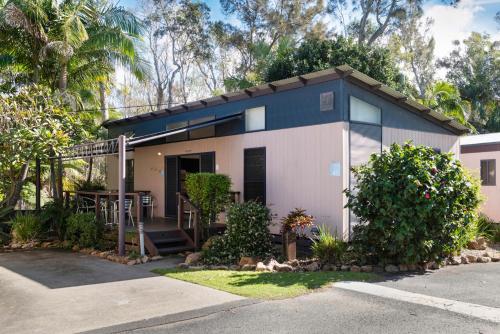 a small house with a lot of plants and trees at Discovery Parks - Emerald Beach in Emerald Beach