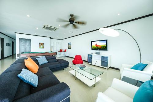 a living room with a couch and a table at Best in Jaco Condos at Diamante del Sol in Jacó