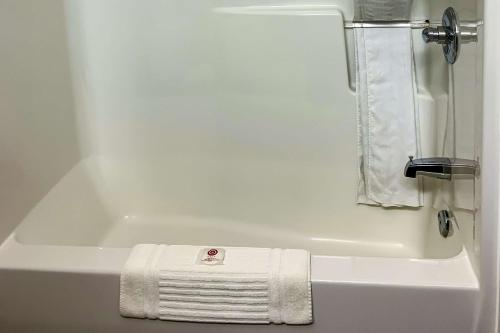 a white bath tub with a towel on it at Comfort Inn in Dawson Creek