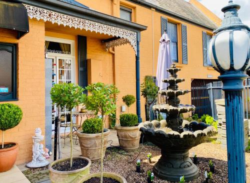 a fountain in a yard in front of a house at The Mews Motel in Launceston