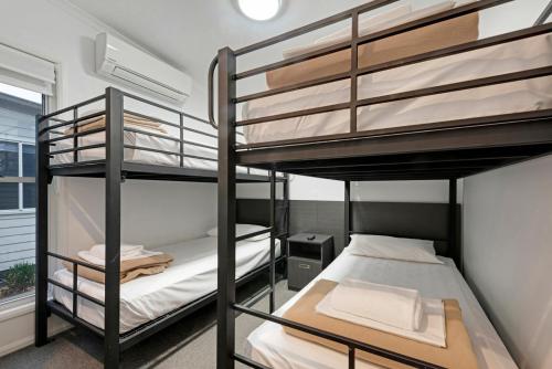 a bunk bed room with two bunk beds at Discovery Parks - Emerald Beach in Emerald Beach