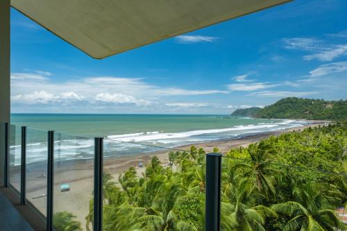 a room with a view of the beach at Best in Jaco Condos at Diamante del Sol in Jacó