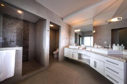 a bathroom with two sinks and a shower at Best in Jaco Condos at Diamante del Sol in Jacó