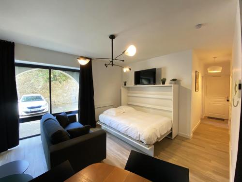 sala de estar con cama y sofá en Céleste - Hypercentre parking privé, en Poitiers