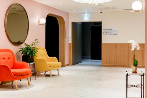 a waiting room with chairs and a mirror at Oriens Hotel & Residences Myeongdong in Seoul