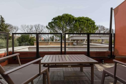 a picnic table and two benches on a roof at Best Western Plus Le Lavarin in Avignon