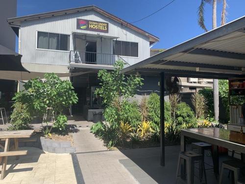 a building with a restaurant with a table in front of it at The Cozy Hostel - Motel in Darwin