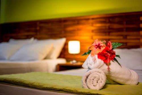 a white teddy bear sitting on top of a bed at Hotel Torres del Mar in Puerto Viejo