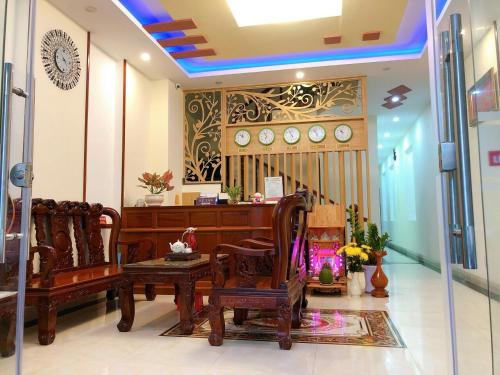 a room with chairs and clocks on the wall at Hotel Hải Trường in Con Dao
