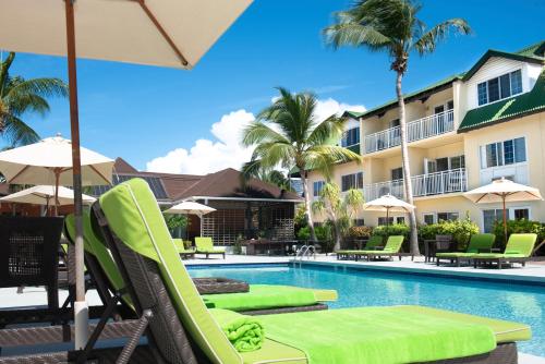 a pool at the resort with chairs and umbrellas at Ports of Call Resort in Grace Bay