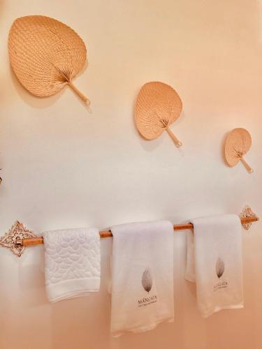 a group of towels hanging on a towel rack at Mangata Boutique Bungalows in Srithanu